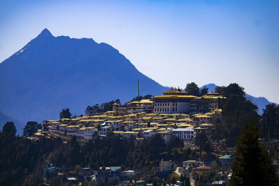 Tawang Monastery on its ridge below a tall mountain in Arunachal Pradesh