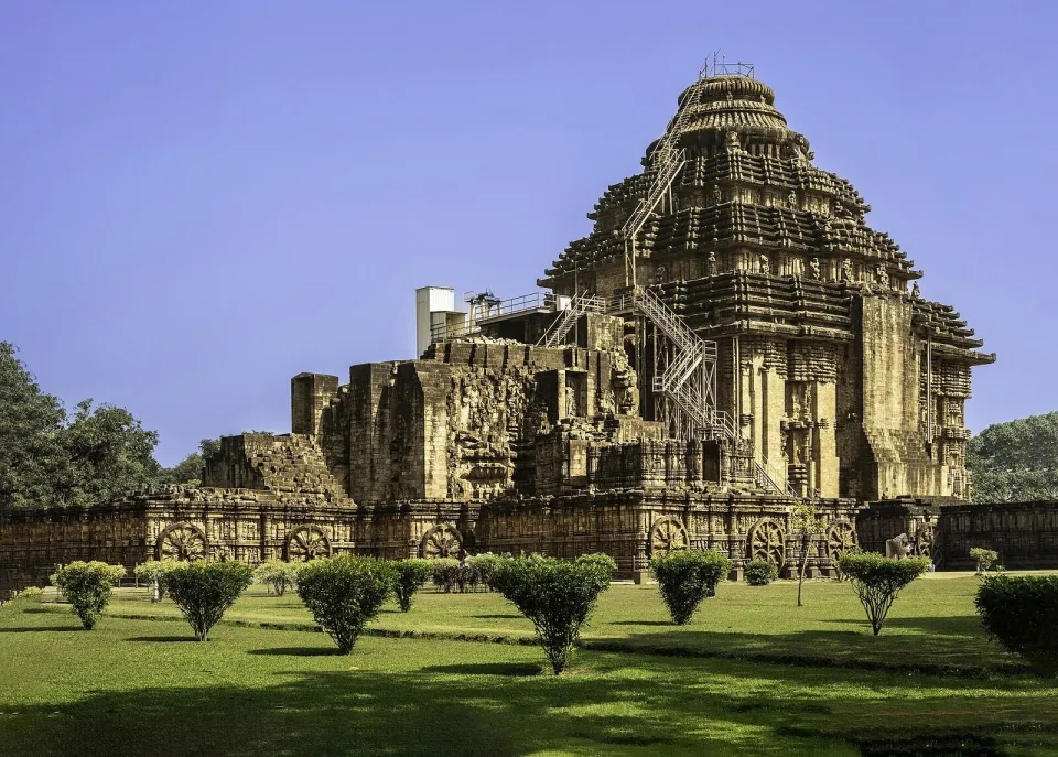 The Konark Sun Temple in Odisha, its carved stone walls under a blue sky