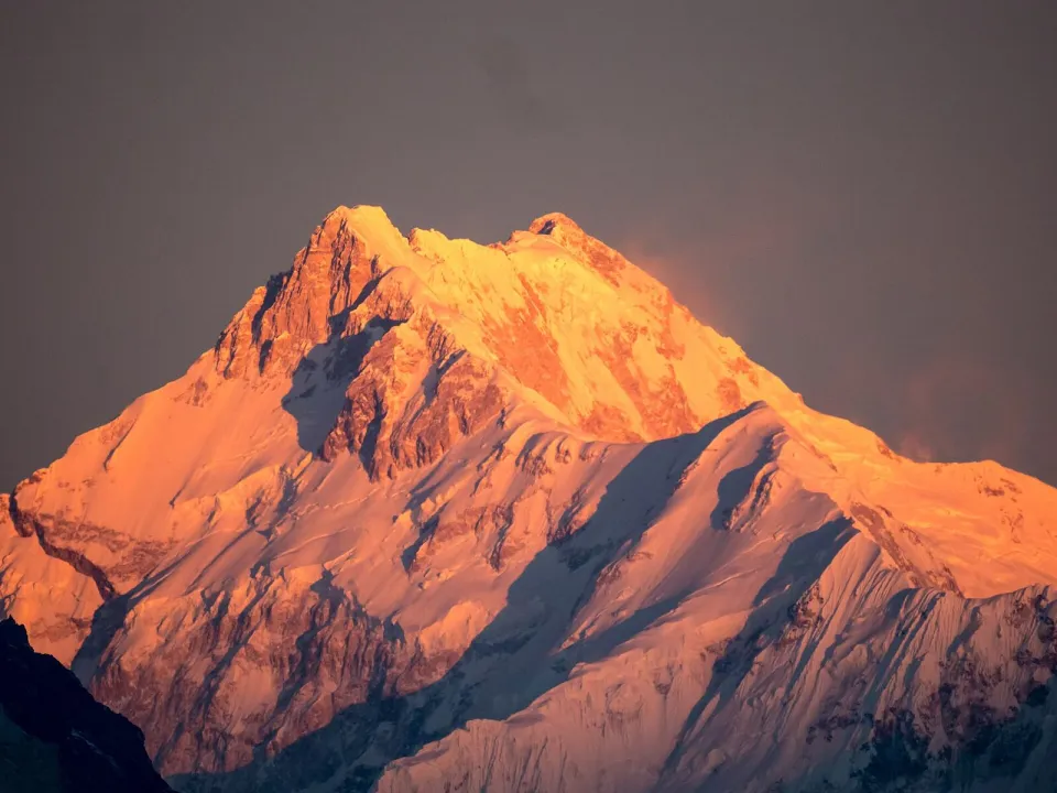 Kangchenjunga glowing orange at sunrise, seen from Sikkim