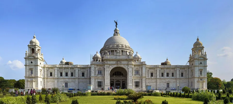 The white marble Victoria Memorial in Kolkata behind its gardens